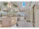 Bright bathroom featuring dual sinks, a soaking tub, and a separate shower at 12504 Ribbongrass Ct, Raleigh, NC 27614