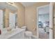 Clean bathroom featuring a white vanity, toilet, and a shower with glass doors at 12504 Ribbongrass Ct, Raleigh, NC 27614