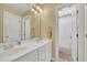 Bathroom with double sink vanity, gold fixtures, and separate room for shower and toilet at 12504 Ribbongrass Ct, Raleigh, NC 27614