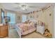 bedroom featuring a ceiling fan, neutral walls, white furniture and window with natural light at 12504 Ribbongrass Ct, Raleigh, NC 27614