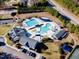 Overhead view of the community pool complex with separate pools, sunbathing areas, and nearby clubhouse at 12504 Ribbongrass Ct, Raleigh, NC 27614