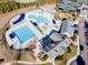 Aerial view of the community pool area featuring multiple pools, lounge areas, and recreational facilities at 12504 Ribbongrass Ct, Raleigh, NC 27614