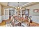 Formal dining room featuring a wooden table with seating for six and decorative hutch at 12504 Ribbongrass Ct, Raleigh, NC 27614
