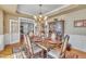 Formal dining room with elegant chandelier and wainscoting provides an ideal entertaining space at 12504 Ribbongrass Ct, Raleigh, NC 27614