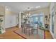 Bright dining room featuring a glass table, chandelier and sliding doors to the exterior at 12504 Ribbongrass Ct, Raleigh, NC 27614