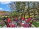 Outdoor firepit area with seating for six around a copper firepit at 12504 Ribbongrass Ct, Raleigh, NC 27614