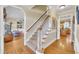 Spacious foyer with hardwood floors, a staircase, and views of the living areas at 12504 Ribbongrass Ct, Raleigh, NC 27614