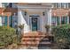 Inviting front entrance with a brick walkway, lovely teal door, and decorative wreath at 12504 Ribbongrass Ct, Raleigh, NC 27614