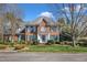 Charming brick two-story home featuring a well-manicured lawn and beautiful landscaping at 12504 Ribbongrass Ct, Raleigh, NC 27614