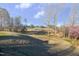 Picturesque golf course view showcasing rolling green hills, mature trees, and manicured fairways at 12504 Ribbongrass Ct, Raleigh, NC 27614