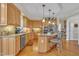 Well-equipped kitchen boasts granite countertops, stainless appliances, light wood cabinets, and island seating at 12504 Ribbongrass Ct, Raleigh, NC 27614