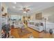 Open-concept living area with hardwood floors, fireplace, and view to kitchen at 12504 Ribbongrass Ct, Raleigh, NC 27614