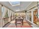 Covered patio with skylights, dining table and curtains and outdoor seating at 12504 Ribbongrass Ct, Raleigh, NC 27614