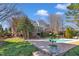 Backyard pool area with a large patio, outdoor seating, and lush landscaping at 12504 Ribbongrass Ct, Raleigh, NC 27614