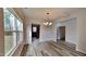 Elegant dining area with hardwood floors and stylish chandelier, adjacent to kitchen and bathed in natural light at 128 Chownings Dr, Sanford, NC 27330