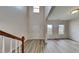 Inviting entryway with soaring ceilings, a staircase, and hardwood floors that create an open and airy atmosphere at 128 Chownings Dr, Sanford, NC 27330