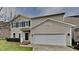 Charming two-story home with a two-car garage, manicured front lawn, and beautiful architectural details at 128 Chownings Dr, Sanford, NC 27330