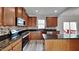 Stylish kitchen with stainless steel appliances, granite countertops, a breakfast bar, and plenty of cabinet space at 128 Chownings Dr, Sanford, NC 27330