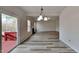 Open living space featuring hardwood floors, a cozy fireplace, and a seamless transition to the outdoor deck at 128 Chownings Dr, Sanford, NC 27330