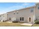 Backyard of townhouse with vinyl siding, small patio, and clear blue skies at 131 Explorer Dr # 257, Morrisville, NC 27560