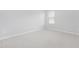 This bedroom features neutral carpeting, white trim, and a bright window allowing natural light at 131 Explorer Dr # 257, Morrisville, NC 27560