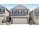 Charming two-story townhome featuring a two-car garage, brick accents and dark shutters at 131 Explorer Dr # 257, Morrisville, NC 27560