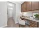 Hallway with built in desk featuring granite countertops and cabinets at 131 Explorer Dr # 257, Morrisville, NC 27560