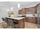 Well-lit kitchen featuring wood cabinets, granite countertops, a kitchen island and stainless appliances at 131 Explorer Dr # 257, Morrisville, NC 27560