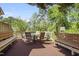Wooden back deck with outdoor seating; offers a relaxing space for enjoying nature with a lovely view at 132 Lord Ashley Rd, Raleigh, NC 27610