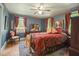 Charming bedroom with hardwood floors, blue walls, decorative accents, and natural light at 132 Lord Ashley Rd, Raleigh, NC 27610