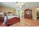 Spacious bedroom with decorative dresser, wood floors, ceiling fan, and a window with natural light at 132 Lord Ashley Rd, Raleigh, NC 27610