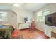 Bright bedroom featuring windows, wood floors, and a classic rocking chair at 132 Lord Ashley Rd, Raleigh, NC 27610