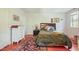 Cozy bedroom featuring hardwood floors, a comfortable bed, and a classic white dresser for ample storage at 132 Lord Ashley Rd, Raleigh, NC 27610