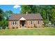 Charming brick home with beautiful landscaping and a well-maintained lawn at 132 Lord Ashley Rd, Raleigh, NC 27610