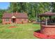 Spacious yard with a brick home, gazebo, and well, perfect for outdoor enjoyment at 132 Lord Ashley Rd, Raleigh, NC 27610