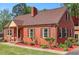 Lovely brick home with neat landscaping and a cozy front porch at 132 Lord Ashley Rd, Raleigh, NC 27610