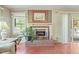 Bright living room with a decorative fireplace and large windows for natural light at 132 Lord Ashley Rd, Raleigh, NC 27610
