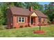 Beautiful red brick home with a cozy front porch and well-maintained landscaping at 132 Lord Ashley Rd, Raleigh, NC 27610