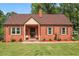 Charming brick home featuring a well-manicured lawn and classic architectural details at 132 Lord Ashley Rd, Raleigh, NC 27610