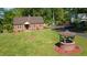 Spacious, green front yard showing a brick wishing well and a manicured landscape at 132 Lord Ashley Rd, Raleigh, NC 27610