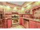Traditional kitchen featuring wood cabinets, granite countertops, and stainless steel appliances at 132 Lord Ashley Rd, Raleigh, NC 27610