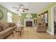 Cozy living room with hardwood floors, neutral seating, a fireplace, and ample natural light at 132 Lord Ashley Rd, Raleigh, NC 27610
