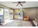 Retro, spacious room featuring a refrigerator, access to a deck, seating, and a unique rug at 132 Lord Ashley Rd, Raleigh, NC 27610