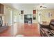 Cozy living room with a brick fireplace, built-in shelving, and access to the backyard at 132 Lord Ashley Rd, Raleigh, NC 27610