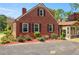 Rear view of a brick home, with an attached sunroom and ample parking space at 132 Lord Ashley Rd, Raleigh, NC 27610