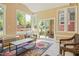 Bright sunroom with wicker furniture, lots of natural light, a decorative rug, and views of the backyard at 132 Lord Ashley Rd, Raleigh, NC 27610