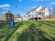 Sprawling back yard featuring a playset with a slide and swing set and beautiful green grass at 132 Mantle Dr, Clayton, NC 27527
