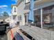 Multi-level backyard deck with table and seating, grill, and access to the house and sun room at 132 Mantle Dr, Clayton, NC 27527