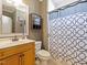 Cozy bathroom featuring a vanity with a sink, toilet and shower with patterned curtain at 132 Mantle Dr, Clayton, NC 27527