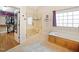 Bright bathroom featuring a soaking tub, glass shower, and walk-in closet at 132 Mantle Dr, Clayton, NC 27527